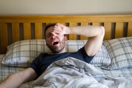 man waking up yawning, sleep and brain recovery